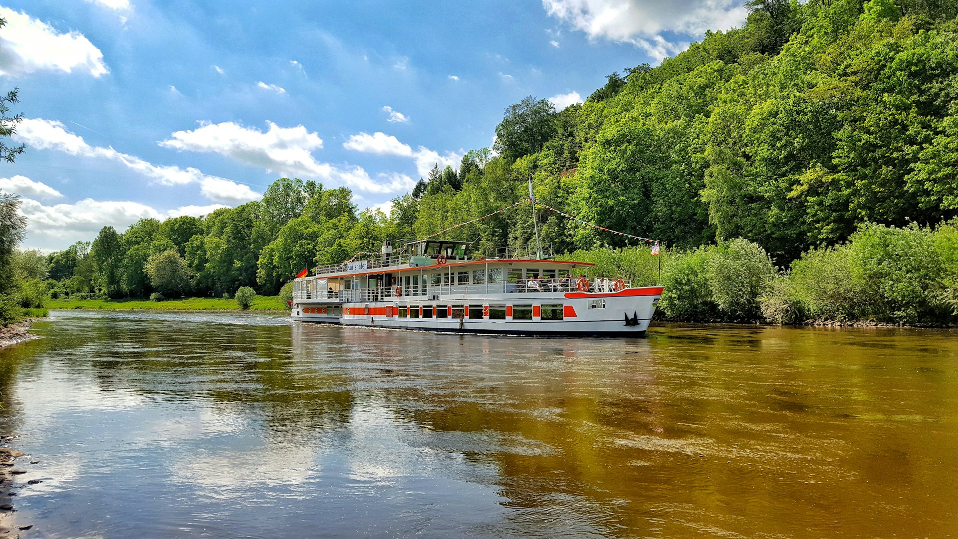 red and white boat on river during daytime